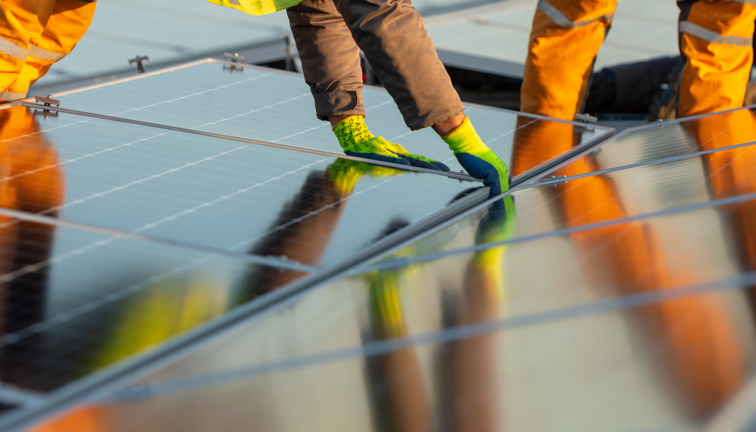 A person installing a solar panel