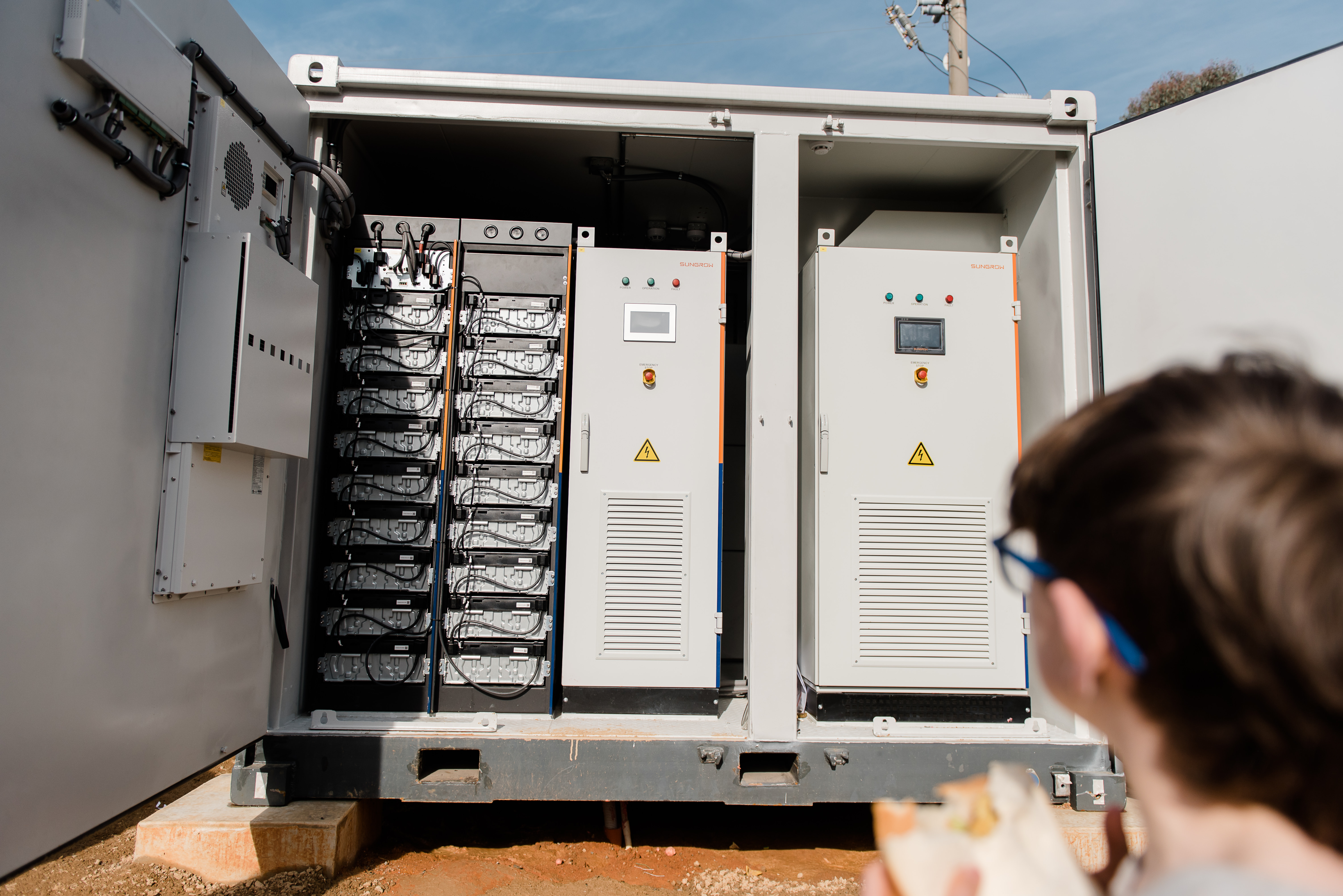 A child looking at a community battery